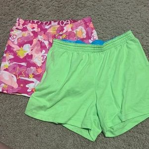 two pair of kids gym shorts, pink is a 10-12 large! green is an XL 14-16